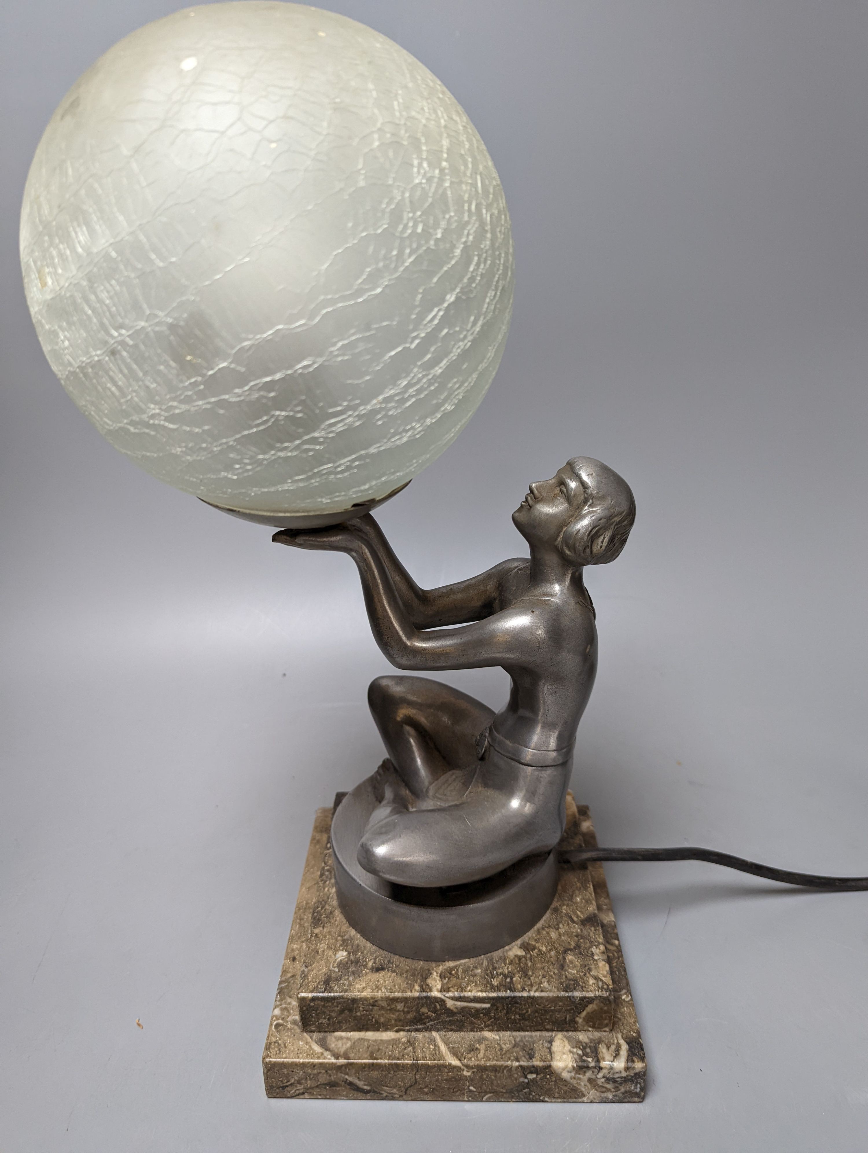 An Art Deco style ‘seated female’ lamp with spherical shade and marble base. 37cm